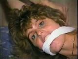 SEXY GO-GO DANCER BRANDI ON BED IN LINGERIE, WHITE PANTIES, & IS MOUTH STUFFED, CLEAVE GAGGED & BOUND TIGHT (D46-11)