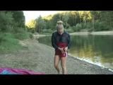 Jenny bathing in a lake and sun bathing wearing sexy red shiny nylon shorts and a rain jacket (Video)