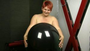 Naked with big black balloon