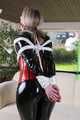 Watch Sophie beeing bound and gagged corsetted in a shiny black PVC catsuit