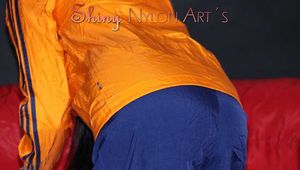 Sexy Lucy wearing a blue shiny nylon rain pants and an orange rain jacket sorting shiny nylon shorts (Pics)