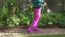 Watching Sandra taking a sun bath and watering the garden the pest plants wearing a sexy purple rain pants and a green down jacket (Video)