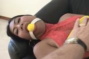 Video - Asian girl Tum is bound on the couch, struggling, gagged and fondled for fun!