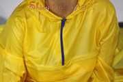 Watching Sandra wearing supersexy shiny nylon rainwear in yellow and orange preparing her bed and lolling in it with this shiny rainwear (Pics)