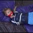 Samantha tied and gagged on bed wearing a shiny light blue nylon shorts and a dark blue rain jacket (Video)
