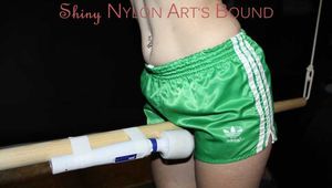 Sonja being tied and gagged overhead on a bar with a massager wearing a sexy green shiny nylon shorts and a black rain jacket (Pics)
