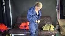 Watching sexy Sandra putting on several layers of shiny nylon rainwear and hoods ending with a lifevest (Video)