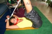 Stella tied and gagged on the floor wearing a shiny nylon rain pants (Pics)