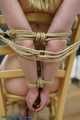 Blonde girl tied up on a chair
