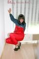 Stella wearing a red shiny nylon rain pants and an oldschool blue/red rain jacket while posing in the living room (Pics)