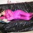 Watching sexy Mara lying on a black shiny sofa wearing a sexy pink downsuit reading a book (Pics)