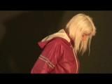 Blonde-haired archive girl posing in sexy shiny nylon rainwear (Video)
