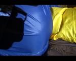 Lucy playing with zipper and lolling on a bed wearing supersexy blue AGU rainwear (Video)