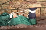 Pia tied, gagged and hooded in a princess bed wearing sexy shiny green rainwear (Pics)