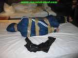 Get 34 Pictures with Angelique tied and gagged in shiny nylon rainwear from 2005-2008!