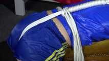 Watching sexy Sonja wearing a sexy shiny nylon shorts in blue and a blue rain jacket being tied and gagged on a stool with ropes and a clothgag (Video)