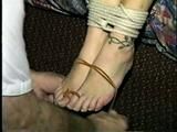 SEXY ONE IS WEARING A DOG COLLAR & CHAIN LEASH & GETS HER BARE FEET & TOES TIED & RUBBED (D35-16)