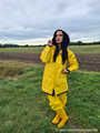 Miss Amira on the road in a Frisian mink, yellow rain dungarees and rubber boots