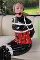 Watch Sophie beeing bound and gagged corsetted in a shiny black PVC catsuit