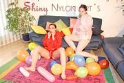 Jill and a friend of her wearing shiny nylon shorts and rain jacket playing with baloons (Pics)