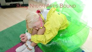 Beautiful archive girl tied and gagged on a blow-up arm chair wearing a sexy yellow shiny nylon shorts and a rain jacket (Pics)