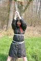 Jill tied, gagged and hooded on a tree outdoor wearing a shiny black down jacket (Pics)