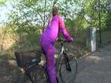 Watch Sandra riding her Bike in her sexy pink shiny nylon Rainsuit