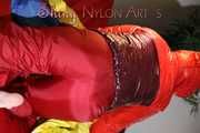 Watching sexy Jill wearing a sexy red shiny nylon rain pants and a red/ purple downjacket lolling in her bed (Pics)