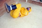 Katharina tied and gagged in a yellow rainsuit