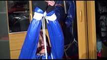 Sonja tied with ropes overhead and gagged with a clothgag wearing sexy black leather pants with a red shiny nylon shorts over it and a special blue down jacket (Video)