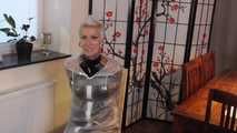 Miss Francine is bound and gagged in a nice short PVC dress covered with a transparent raincoat