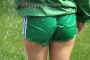 Watching sexy Sandra wearing a sexy green shiny nylon shorts and a green shiny nylon rain jacket enjoying the garden shower (Pics)