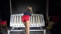 Sexy Sandra preparing her bed with yellow shiny nylon cloth wearing a sey red shiny nylon shorts and a black tshirt (Video)