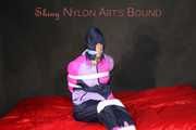 Watching Pia wearing blue/pink shiny nylon rainwear being tied and gagged and hooded with tape and a clothgag (Pics)