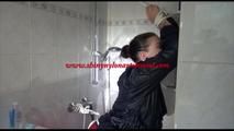 Jill tied and gagged taking a shower wearing sexy shiny nylon shorts and a rain jacket (Video)