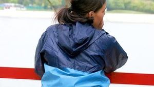 Enni wearing sexy shiny nylon shorts and rain jacket while stretching herself on a sea (Pics)