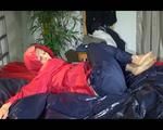 Sonja posing and lolling on bed wearing a sexy blue/red rainwear combination (Video)