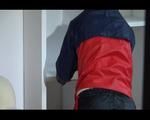 Sonja preparing her move to another flat wearing a sexy black shiny nylon shorts and an oldschool red/blue rain jacket (Video)