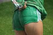 Watching sexy Sandra wearing a sexy green shiny nylon shorts and a green shiny nylon rain jacket enjoying the garden shower (Pics)