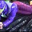 Pia tied, gagged and hooded with cuffs on a bed wearing a sexy purple rain pants and a purple down jacket (Video)