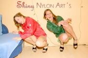 Leonie and Stella posing and having fun with eachother wearing supersexy shiny nylon shorts and rain jackets (Pics)