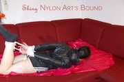 LUCY tied and gagged with ropes and a cloth gag on a sofa wearing a supersexy black shiny nylon shorts and black rain jacket (Pics)