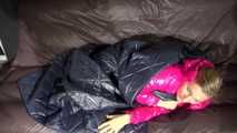 Watching sexy Sandra wearing a sexy pink shiny nlon rain pants and a shiny nylon pink down jacket nestle down in a down cover (Video)