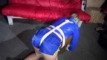 Watching sexy Sonja wearing a sexy shiny nylon shorts in blue and a blue rain jacket being tied and gagged on a stool with ropes and a clothgag (Video)