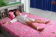 Asian Girl is Tied Spread on the Bed