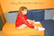 Leonie tied and gagged on a sofa wearing shiny nylon shorts and a rain jacket (Pics)