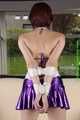 Danny bound in a shiny purple Skirt and Bra, gagged with a Silkscarf