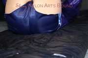 Watching sexy Pia wearing a sexy blue oldschool shiny nylon shorts and a rain jacket being tied and gagged on hands and feet on the ceiling lying on the floor (Pics)