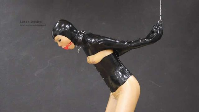 Gagged rubber doll in monogloves