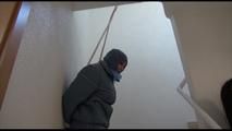 Jill tied, gagged and hooded in an stairway wearing a sexy shiny grey downwear (Video)